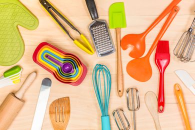 Overhead view of various kitchen gadgets and tools on a wooden tabletop