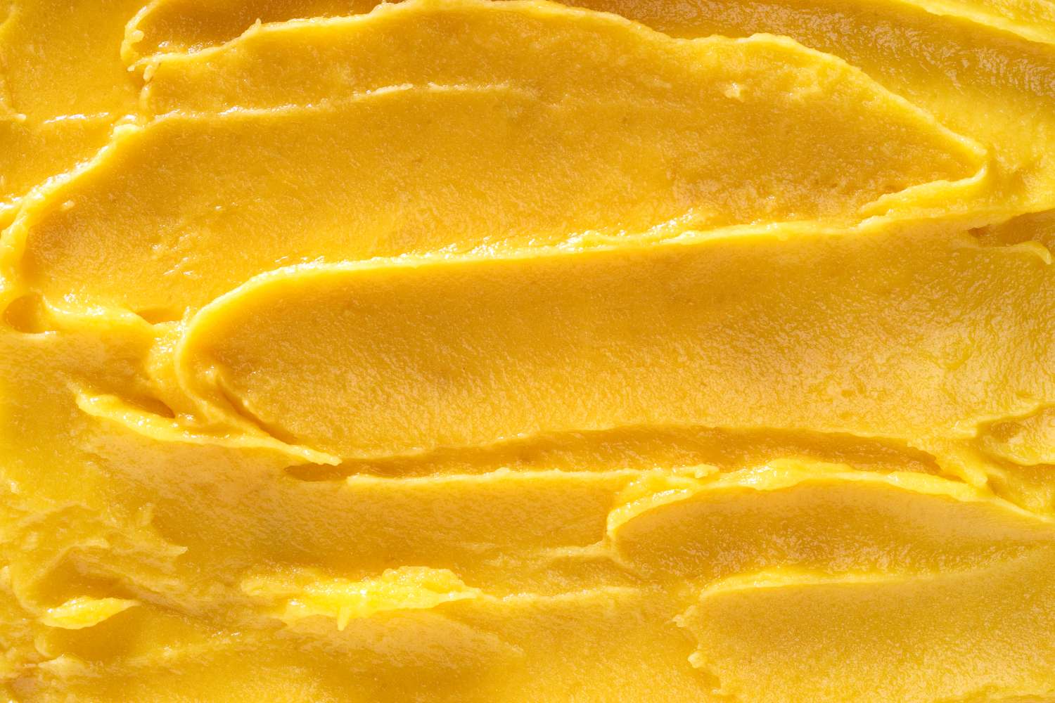 Closeup of a frozen dessert smooth and yellow in texture appears creamy
