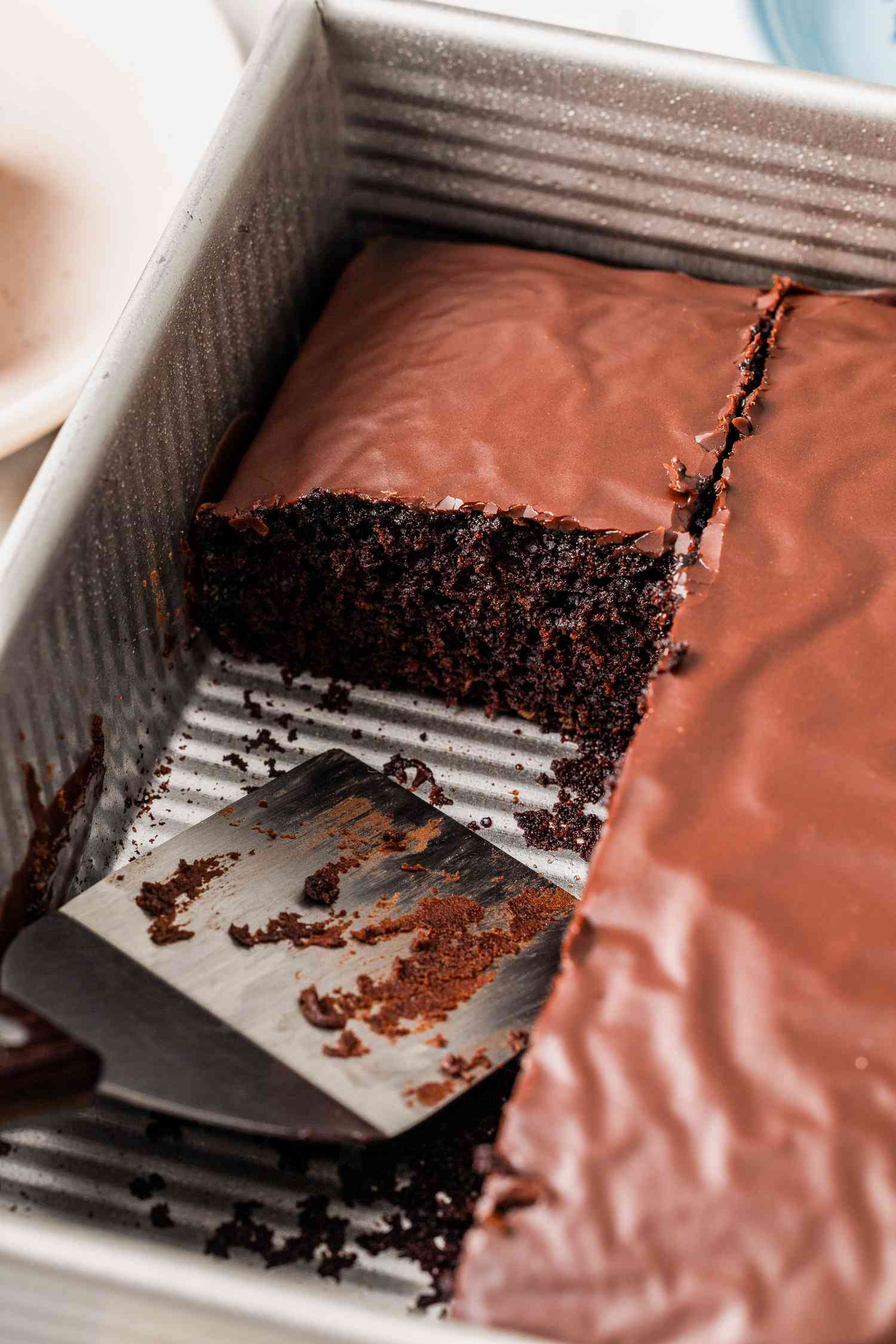 Chocolate depression cake with a few pieces cut out (still in the baking pan)