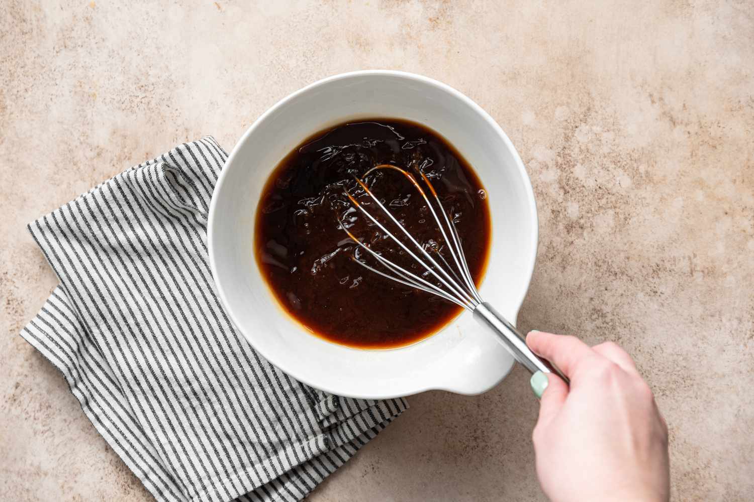 Mixing a bowl of sauce for an Easy Beef Brisket recipe