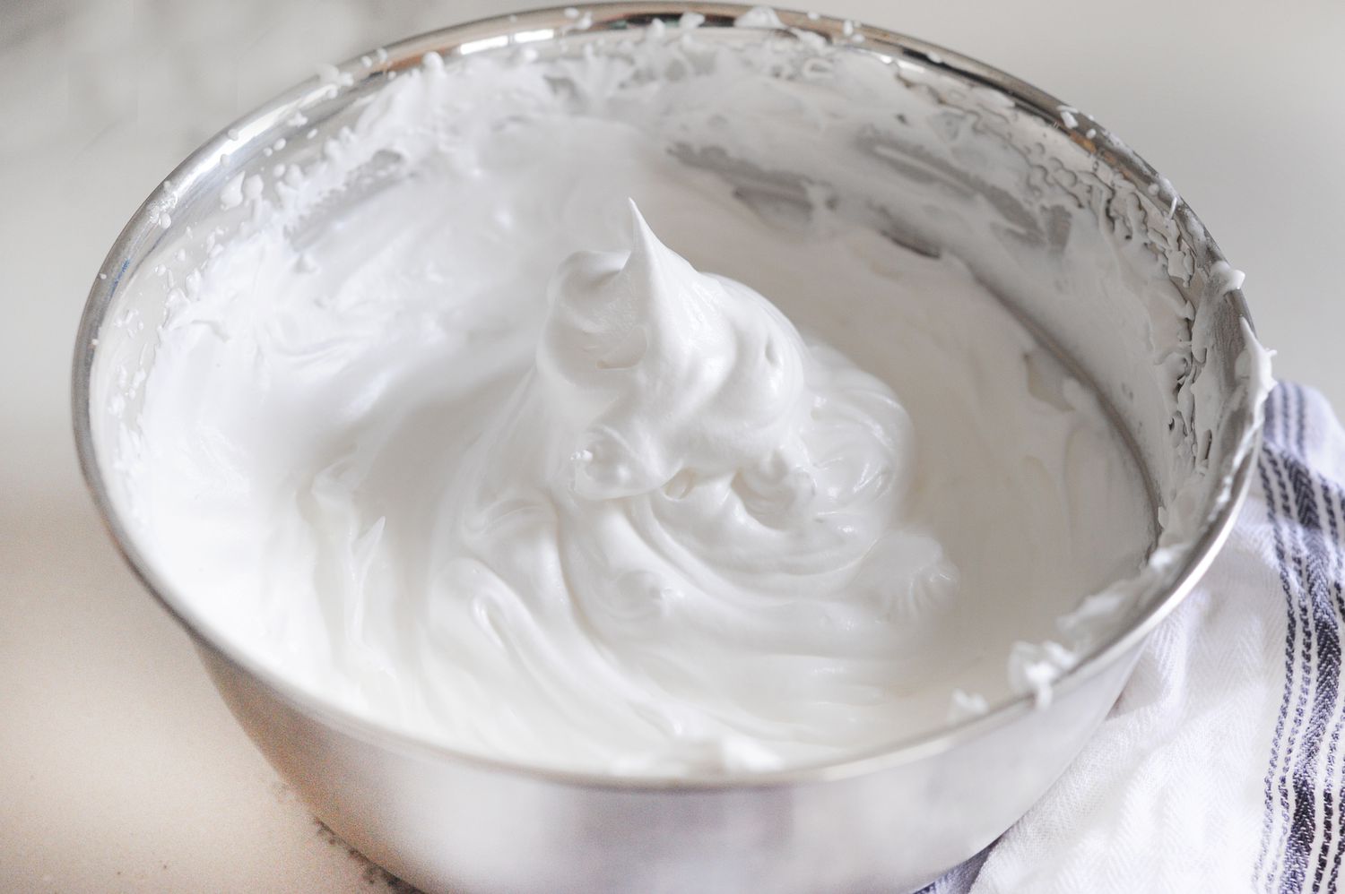Easiest Frosting Recipe You’ll Ever Make whipped in a metal bowl.