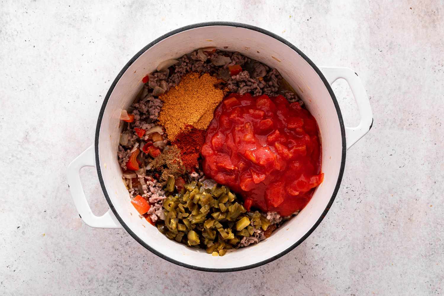 Taco Seasoning and Canned Diced Tomatoes Added to Pot With the Rest of the One-Pot Pasta Ingredients