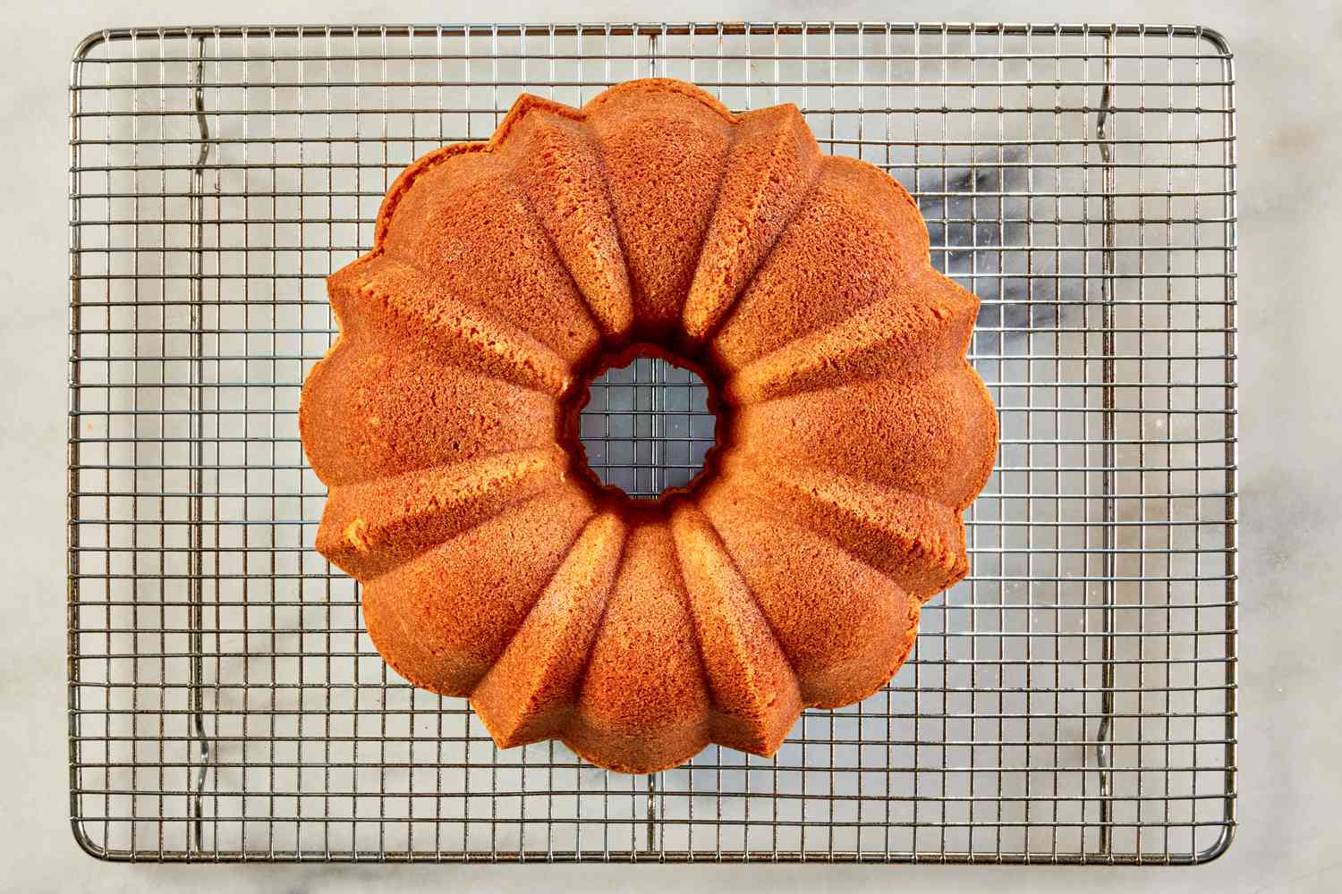 7UP bundt cake cooling (out of pan) on a cooling rack for 7UP bundt cake recipe