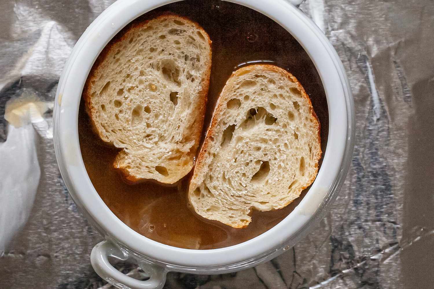 Lay baguette on top of soup.