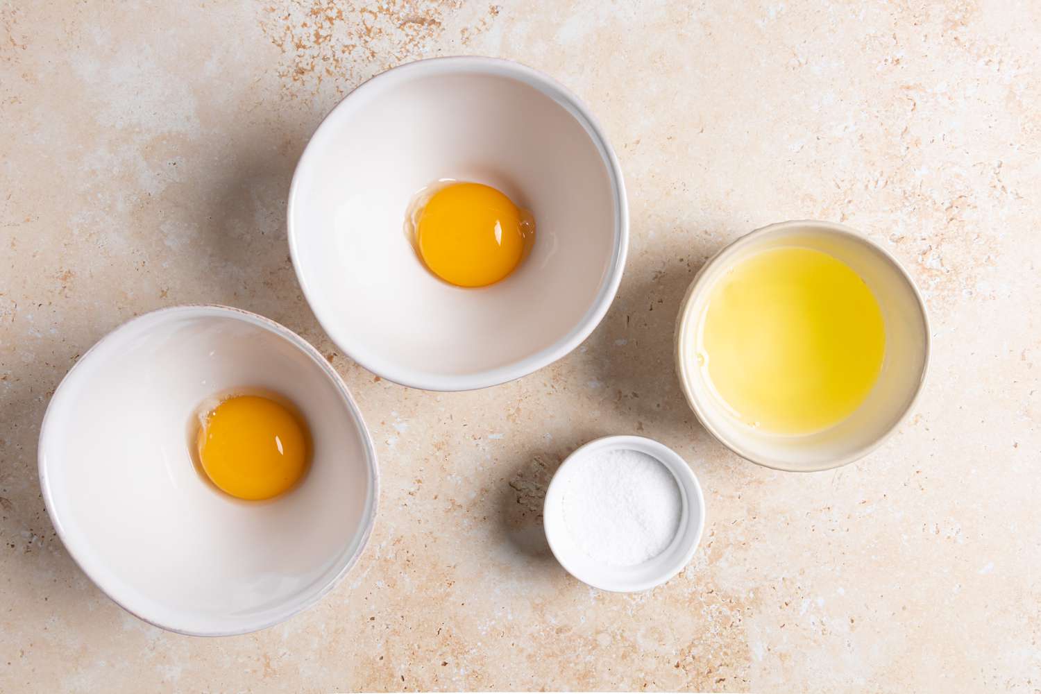 Eggs separated in bowls to make egg nests