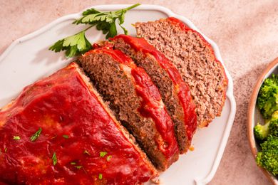 Easy Meatloaf With Some of It Cut Into Slices, All on a Platter, and Next to It, a Bowl of Broccoli