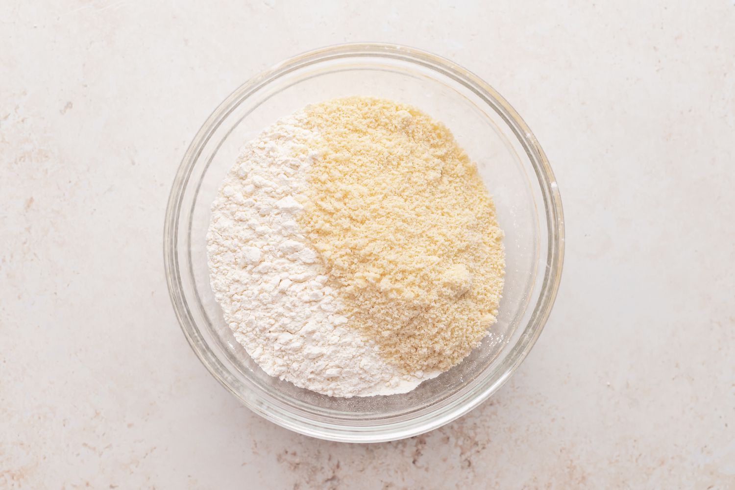 Mixing dry ingredients for almond crescent cookies.