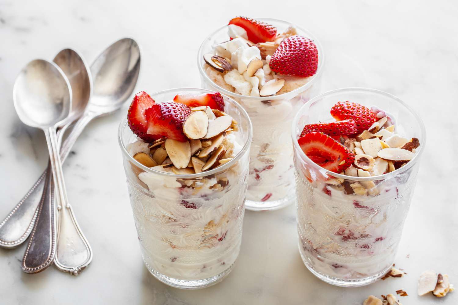 Glasses of Strawberry Eton Mess with Spoons