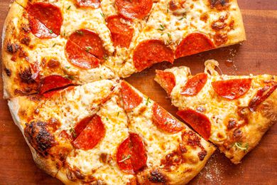 Pepperoni pizza on a wooden board 