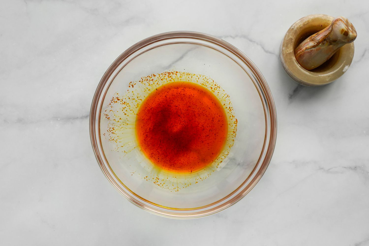 Saffron Crushed Using a Mortar and Pestle and Bloomed in a Bowl of Water for Sabzi Polo (Persian Herb Rice) Recipe