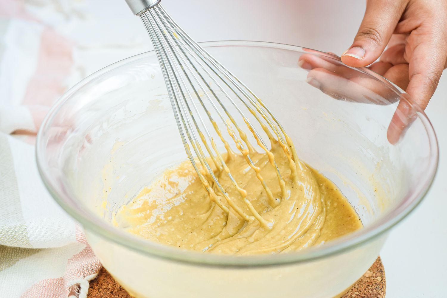 Whisking custard in a bowl to make a sabayon recipe.