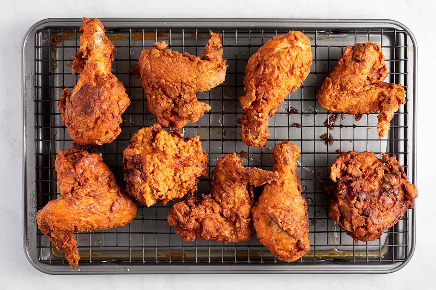 Piri piri fried chicken on sheet tray with wire cooling rack
