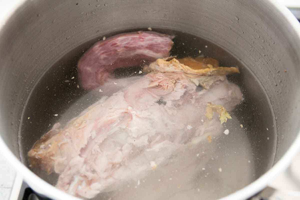Turkey carcass resting in a pot of water