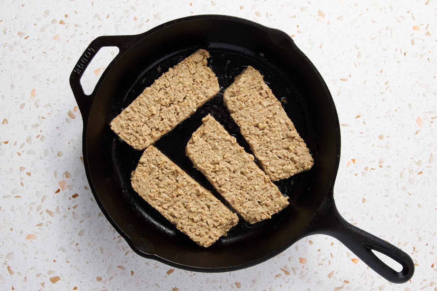 Goetta Slices Fried in a Cast Iron Skillet for Goetta Recipe