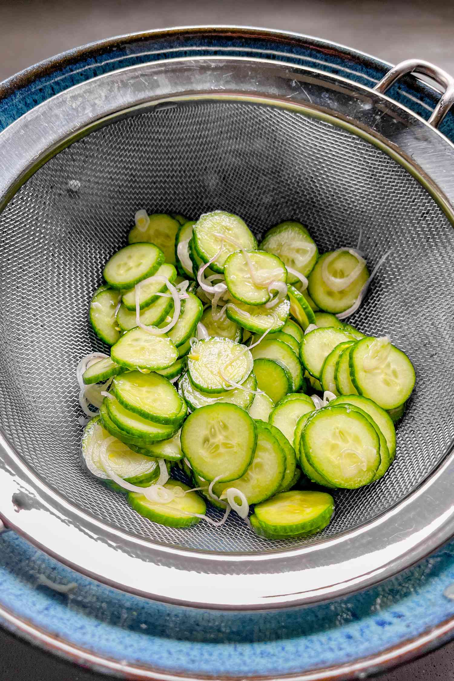 salted cucumbers in a colander 