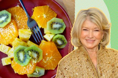 Martha Stewart next to a plate of fruit slices including kiwi, orange, and pineapple