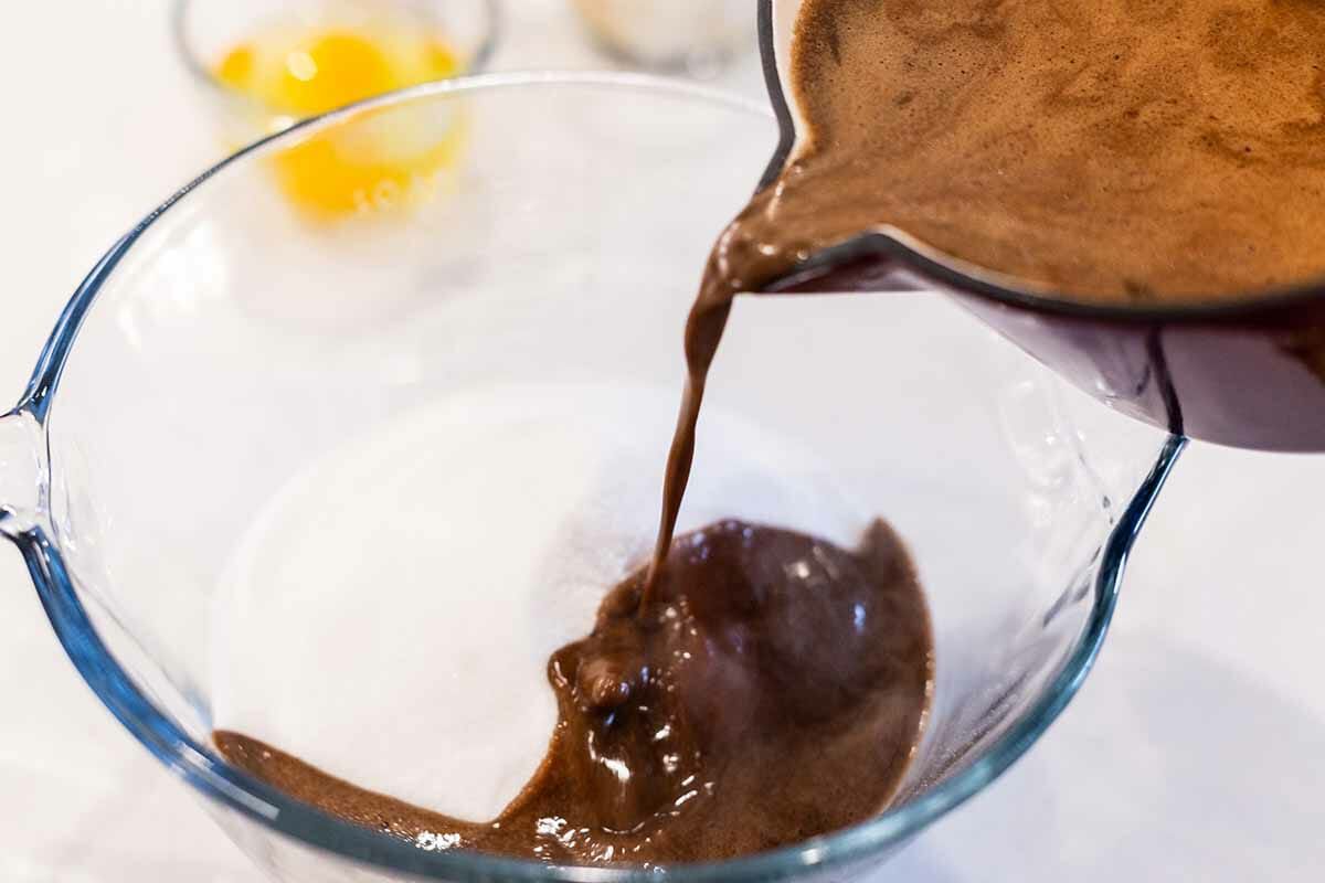 Pouring batter into a bowl to make chocolate sheet cake.