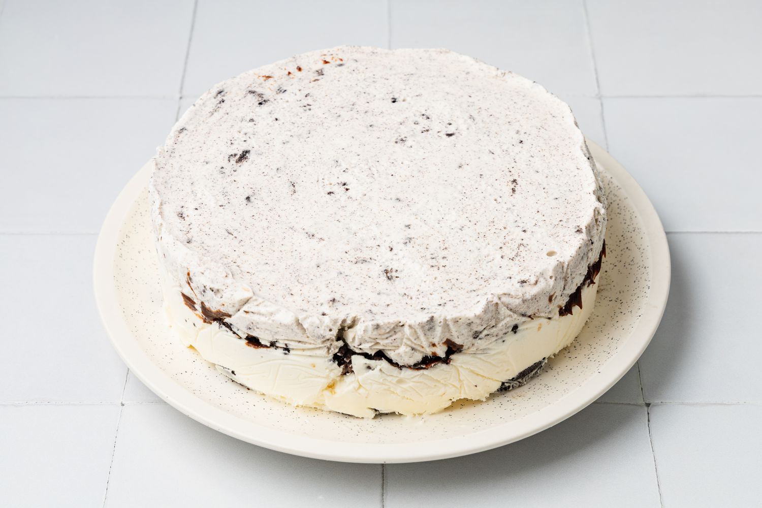Oreo Ice Cream Cake on a Plate After Removed From Plastic Wrapped Cake Pan