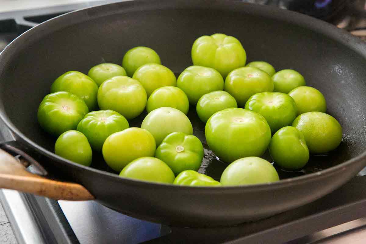Tomatillos being pan roasted 