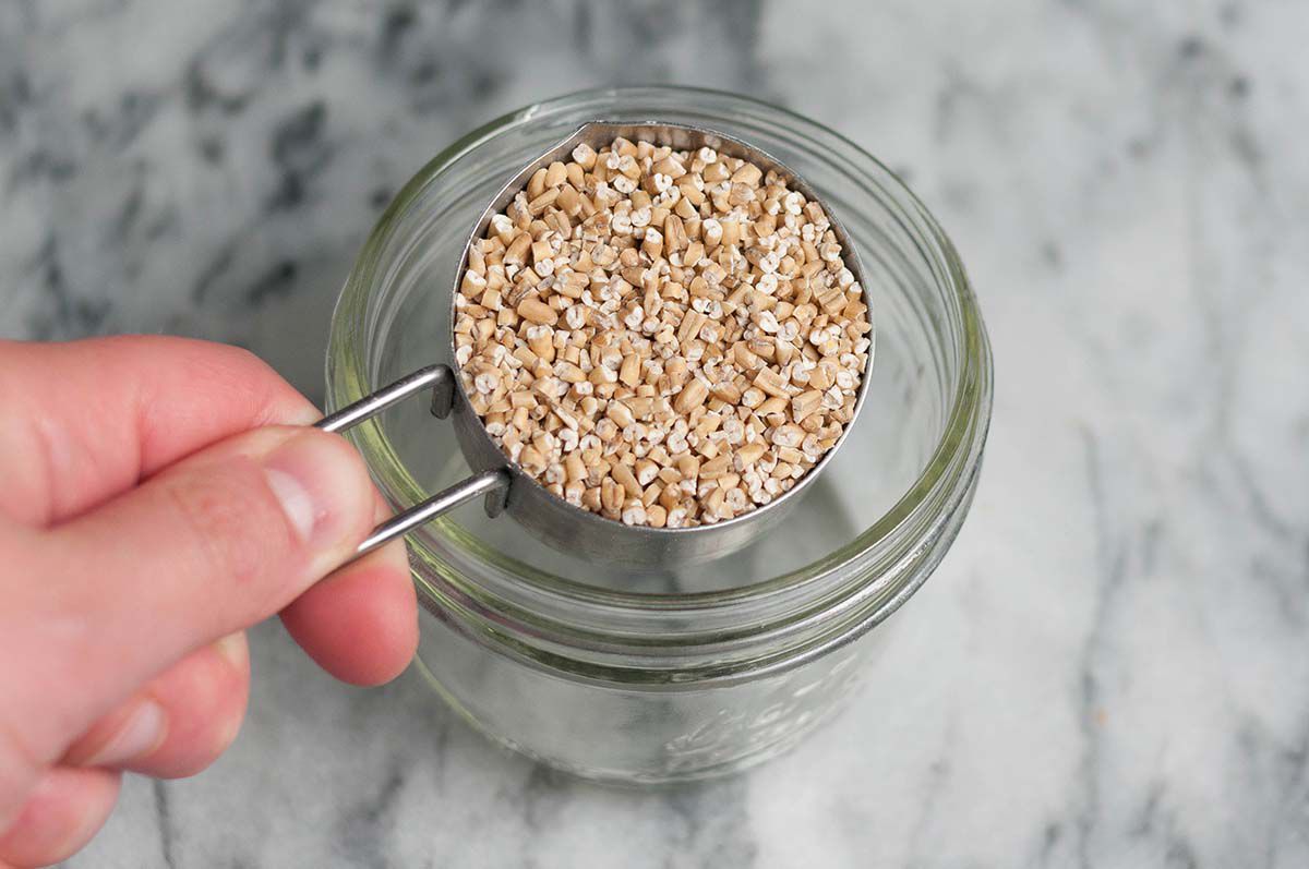 Pour steel cut oats into a jar for making easy overnight oats