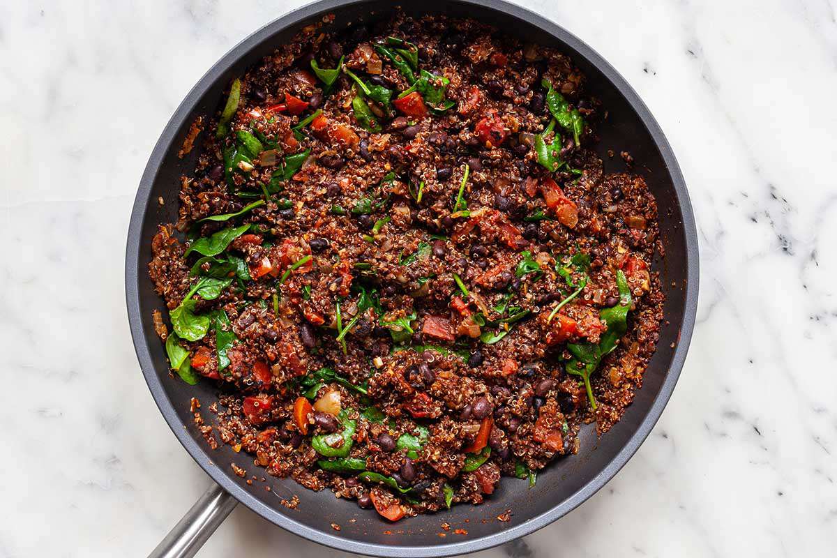 Filling for easy vegetarian skillet dinner in a saute pan on a marble background.