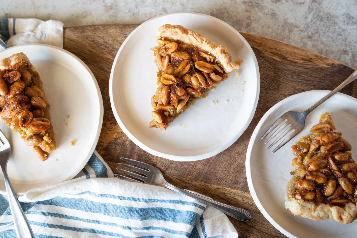 Overhead view of Homemade Peanut Pie with Porter on three plates next to each other.