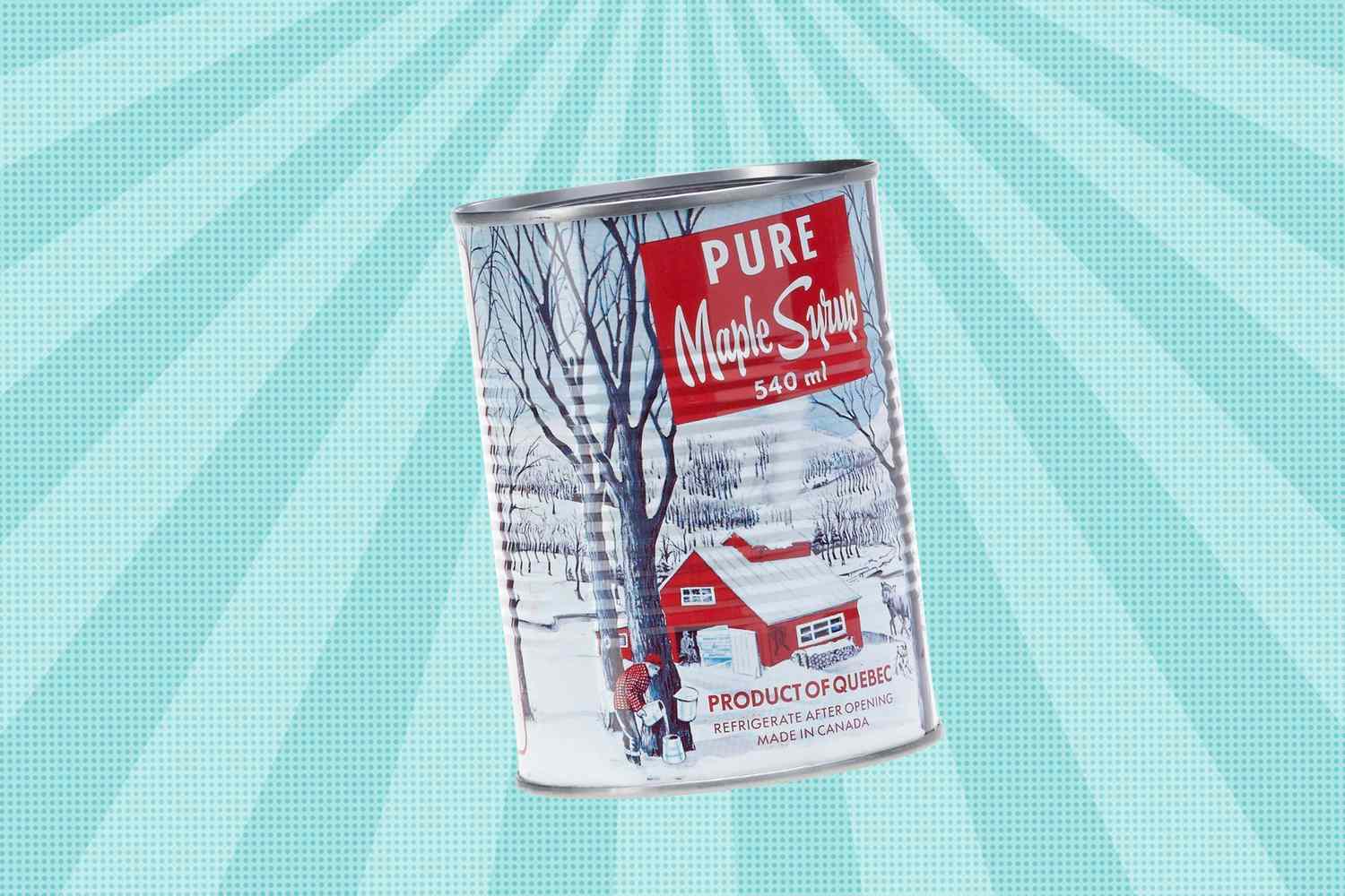 A tin can of pure maple syrup labeled Product of Quebec against a light patterned background