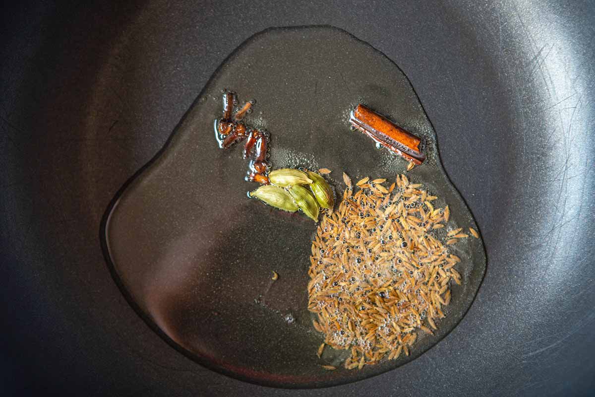 Indian Chana Masala Recipe - oil and spices in a pan