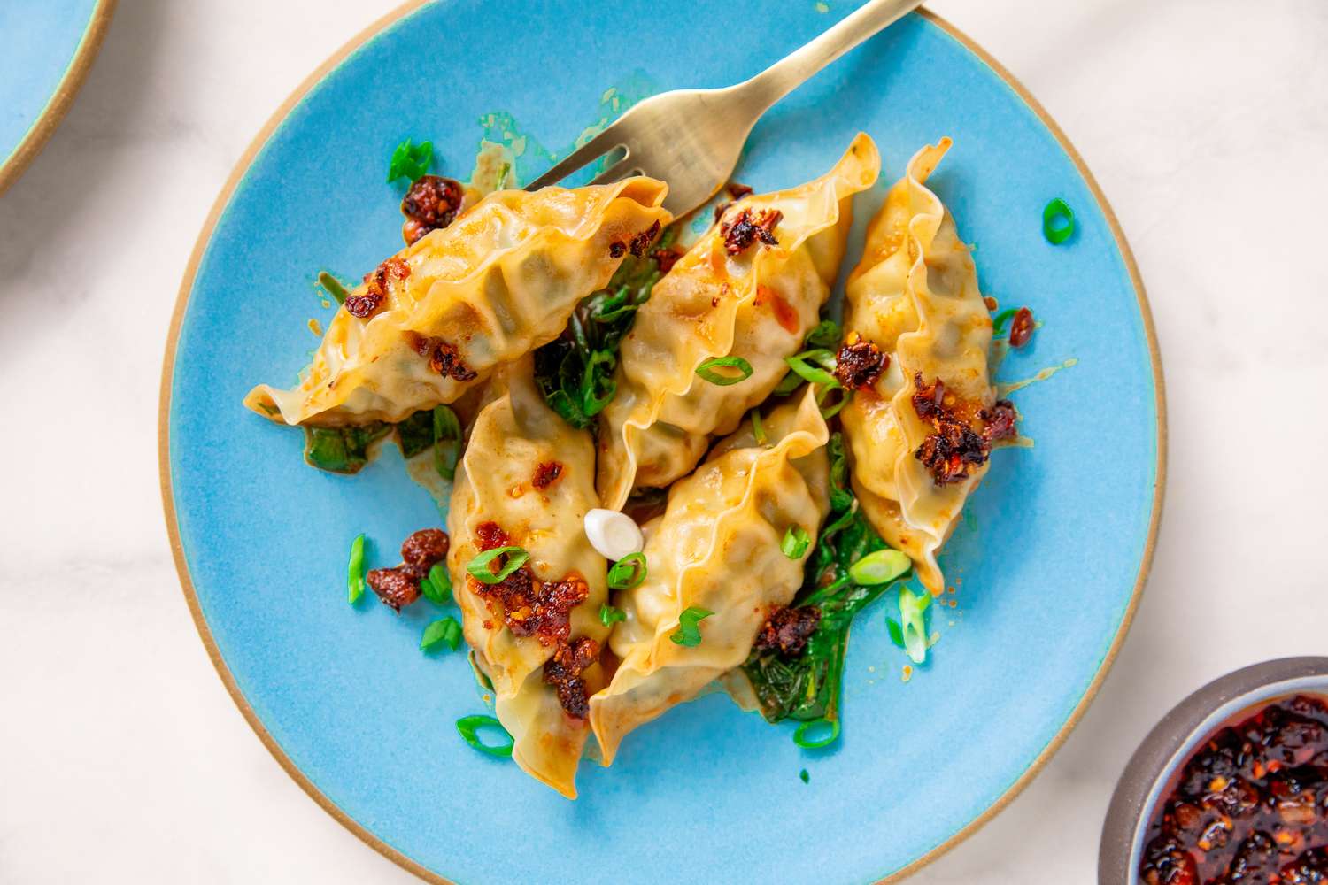 one serving of Dumpling Bake With Peanut Butter Sauce on a plate with a fork