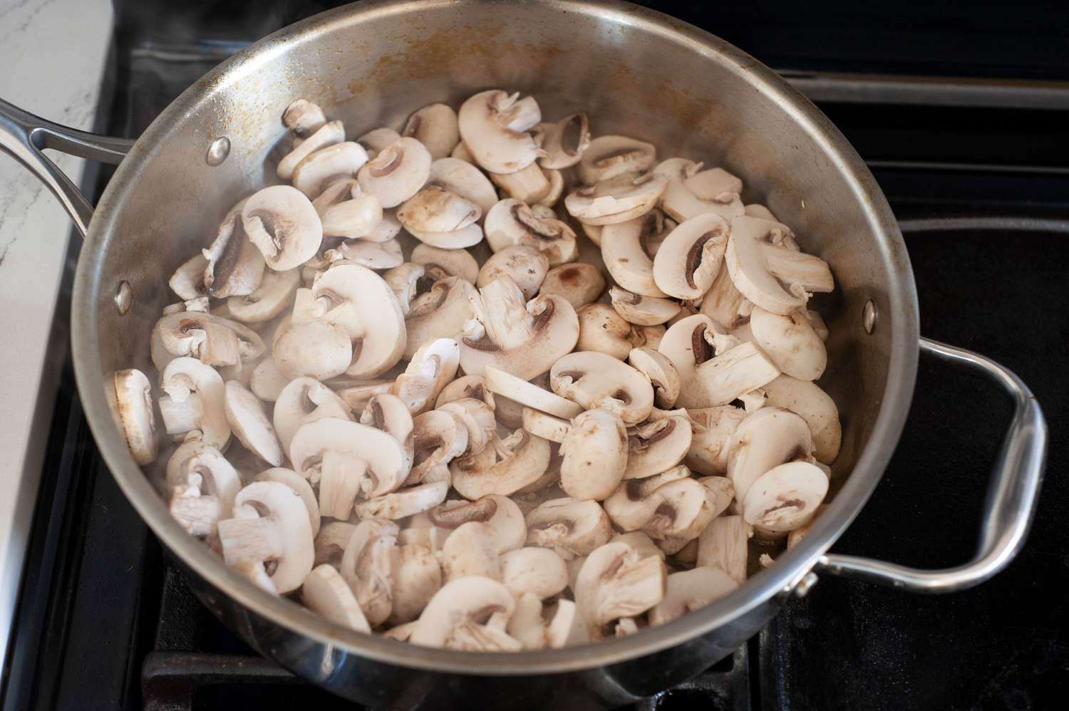 Add mushrooms to hot skillet.