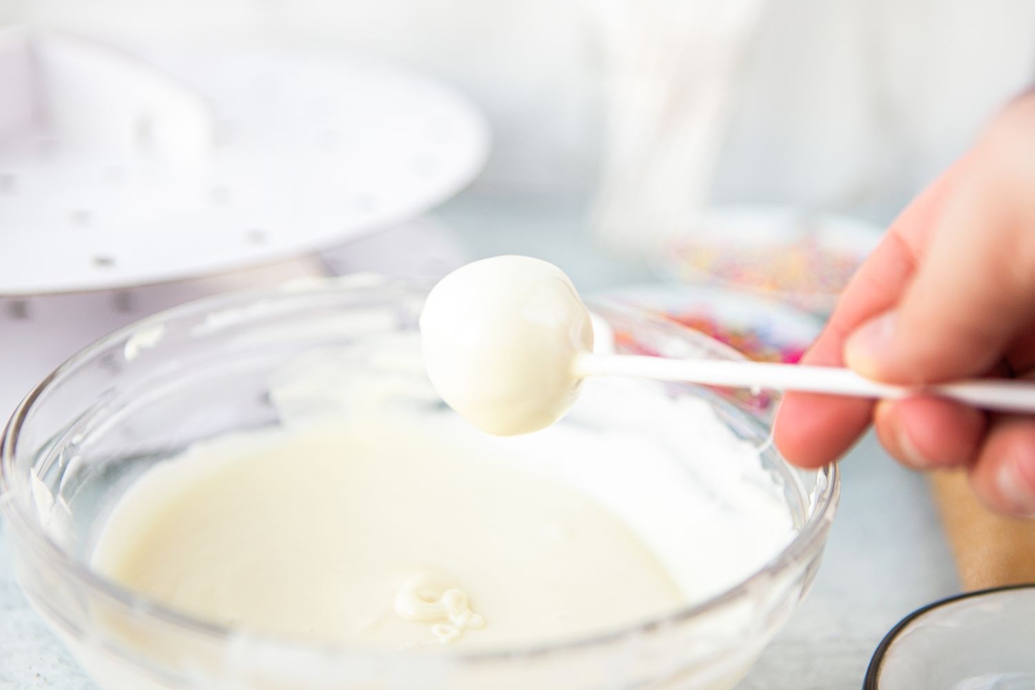 Cake Pop on a Stick Dipped in Bowl of White Chocolate