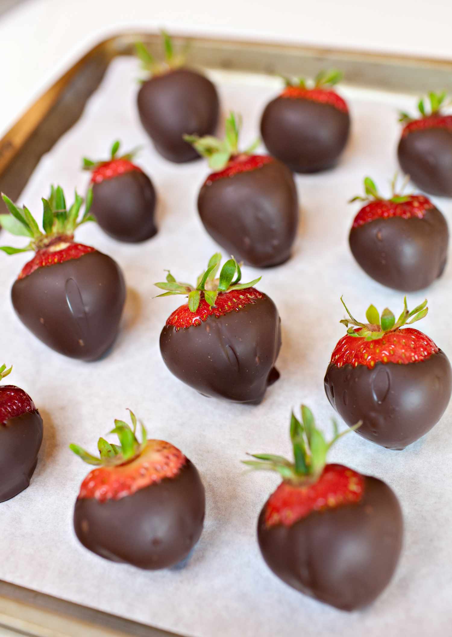Chocolate Covered Strawberries on a Parchment Lined Baking Sheet for How to Temper Chocolate