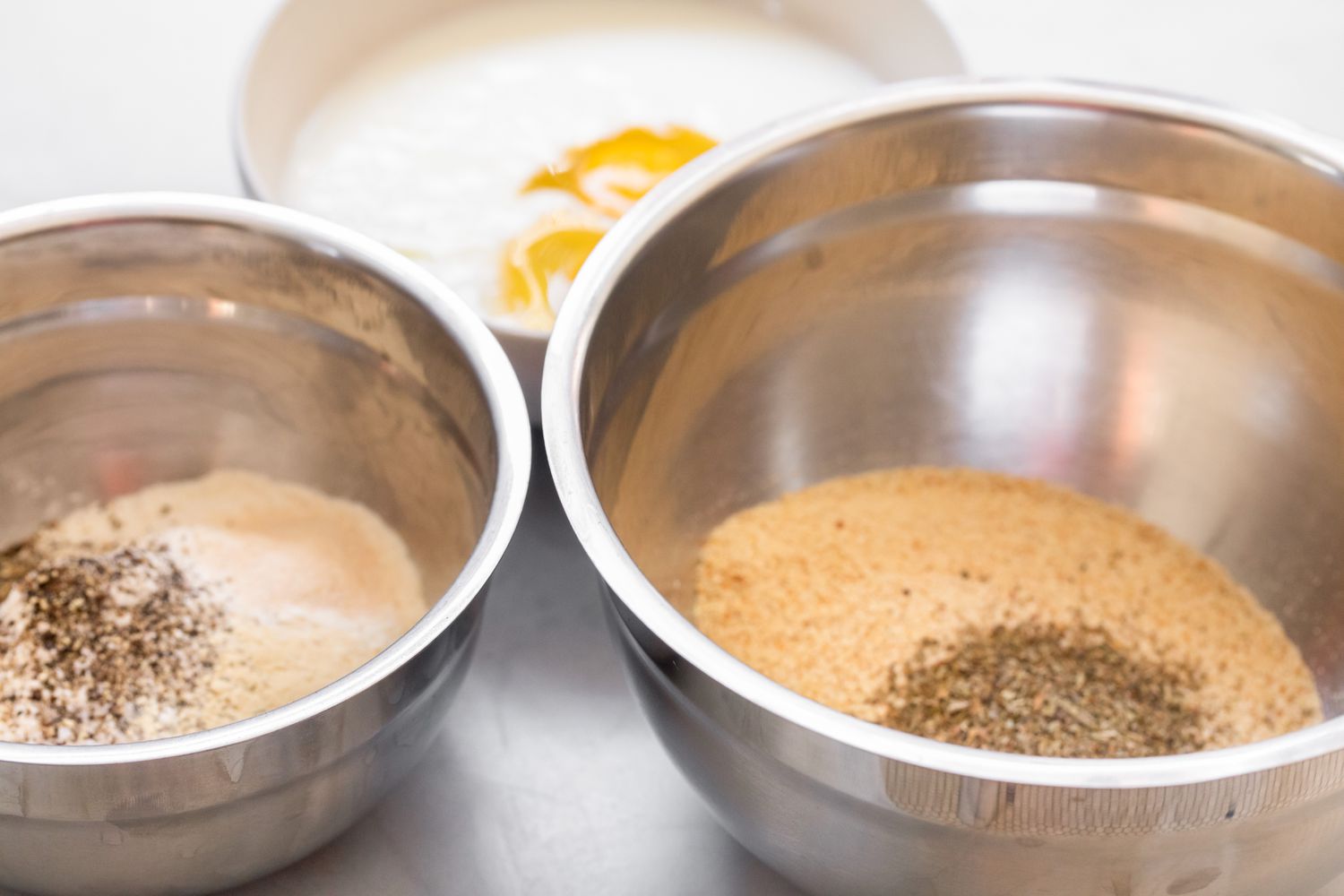 Three Bowls with Dredging Ingredients for Fried Pickles Recipe