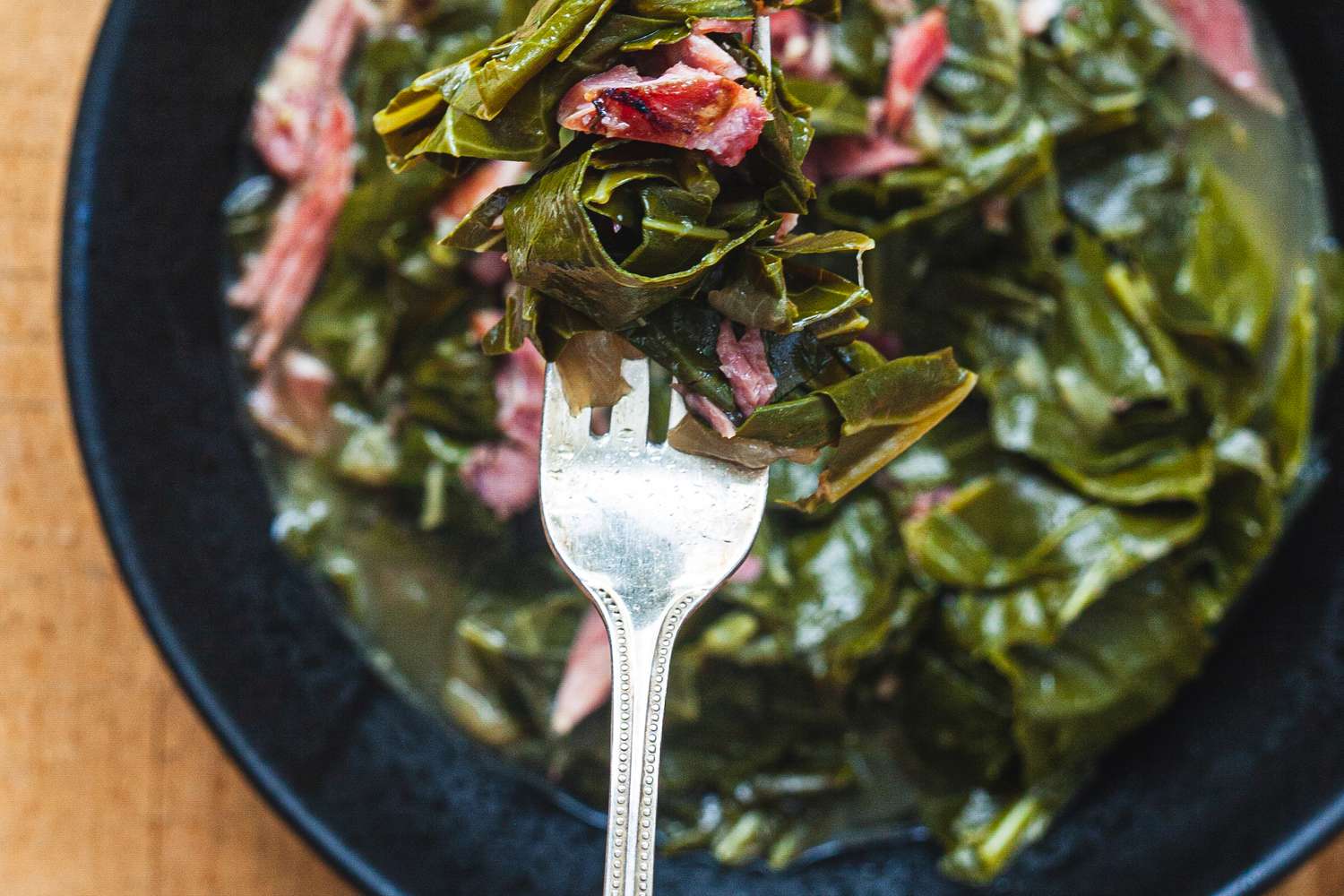 Overhead view of a bowl of collard greens and pot liquor.