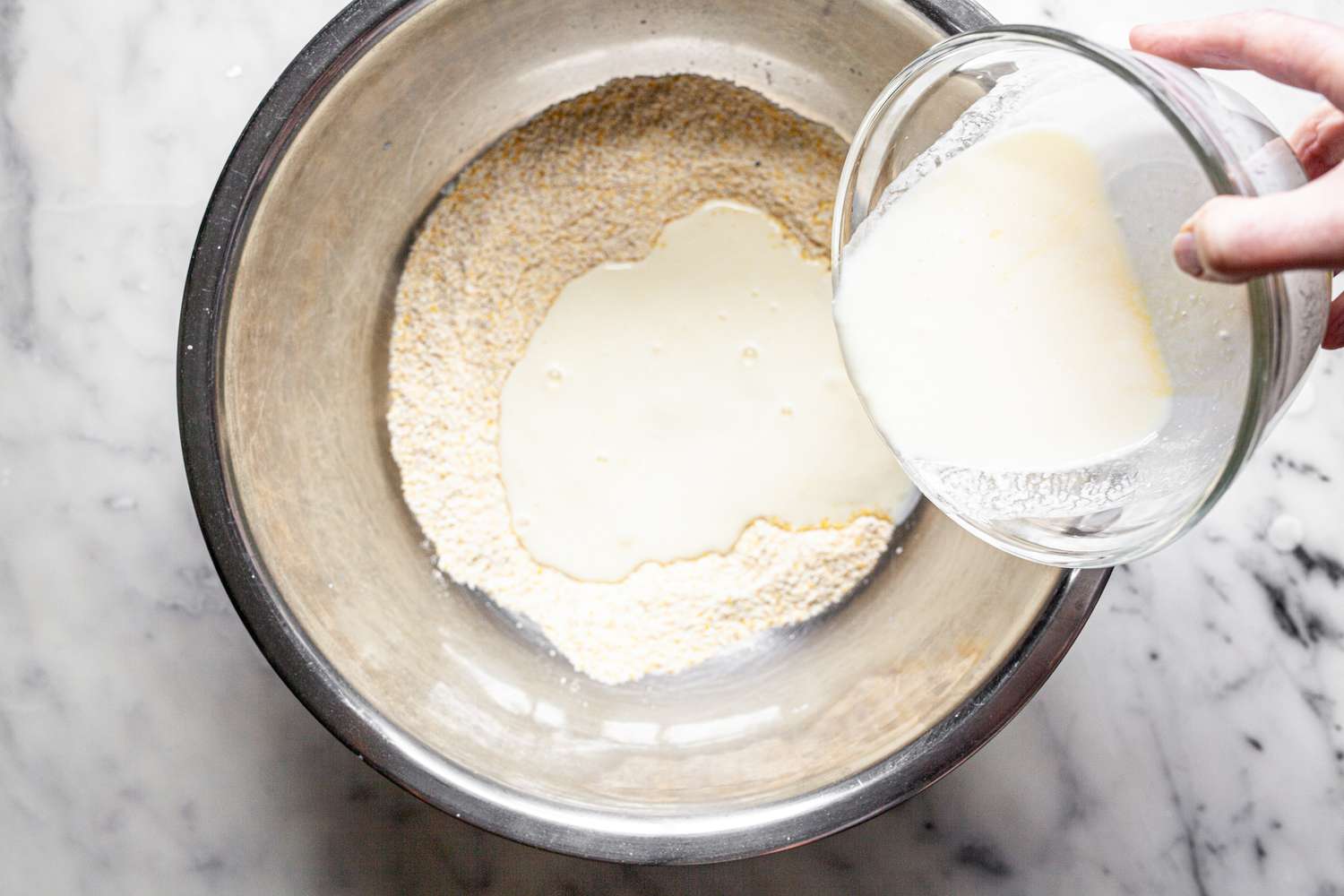 Wet Ingredients Poured into a Bowl with Dry Ingredients for Cornbread