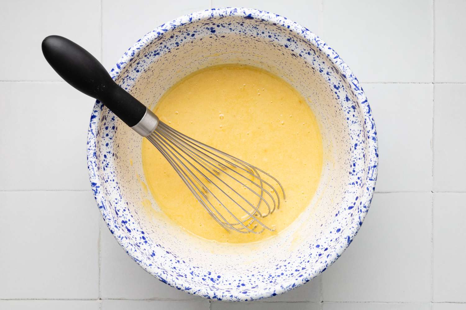 Bananas Whisked Into Bowl of Wet Ingredients for Banana Chocolate Chip Muffins Recipe