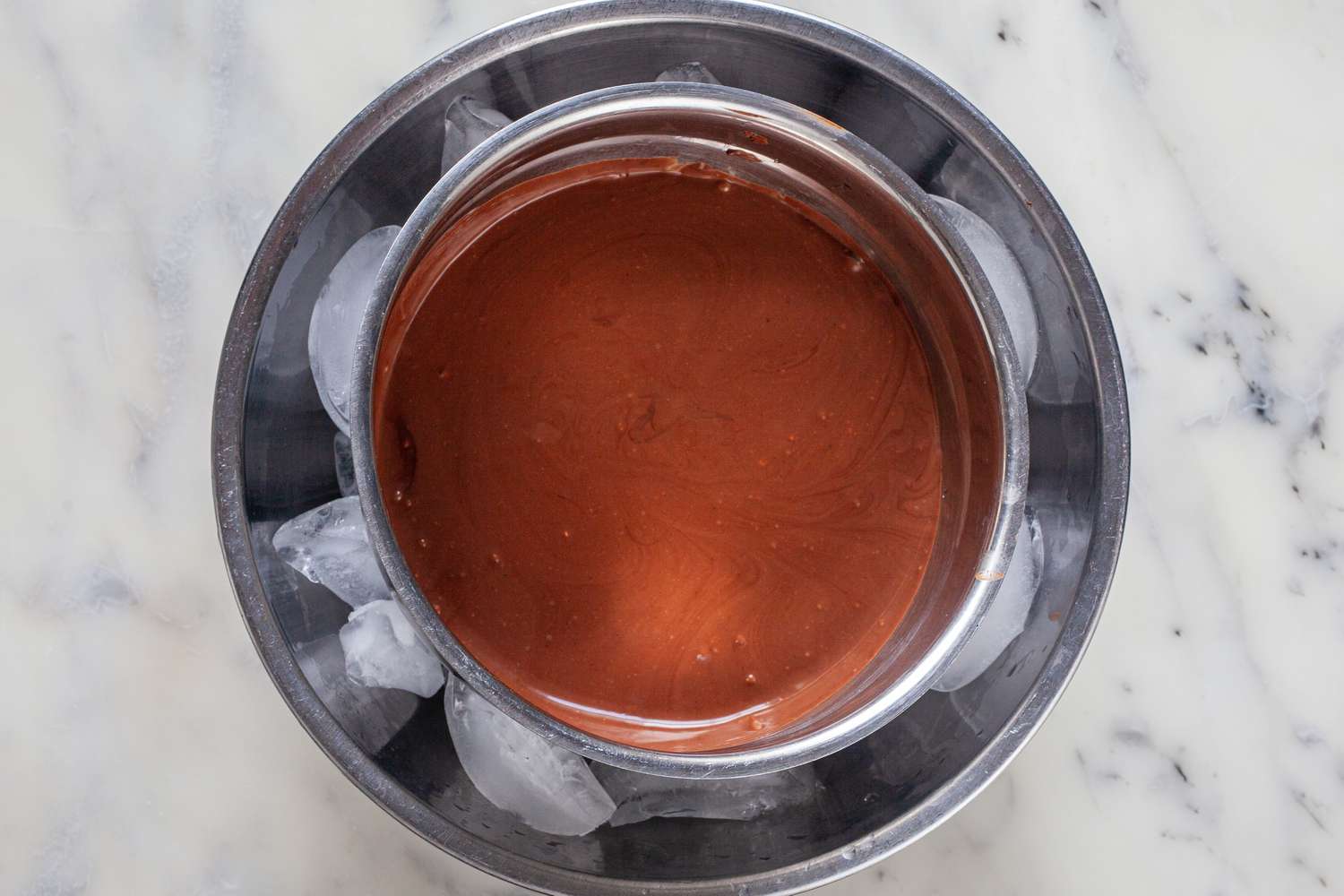 Chocolate mixture chilling over an ice bath to make mexican chocolate.