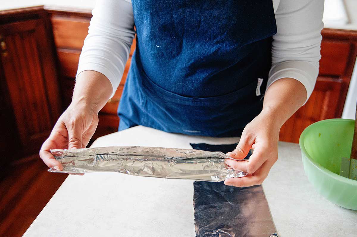 Old Fashioned Rhubarb Pie - tearing aluminum foil in half