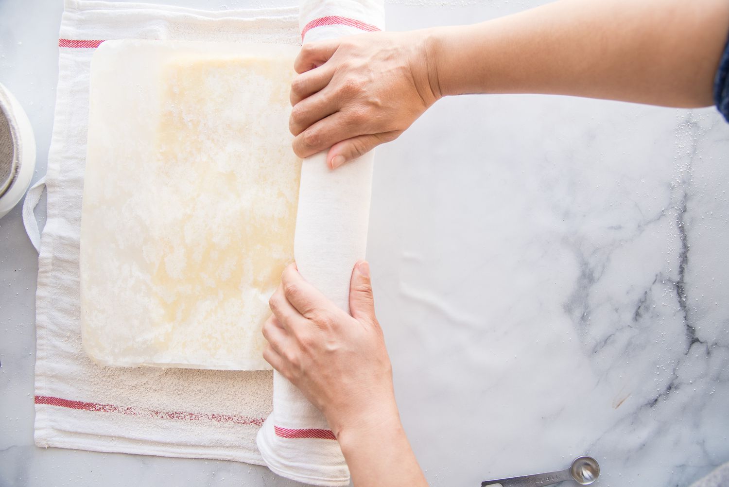 Rolling up a Brazo Gitano (Spanish Roll Cake).
