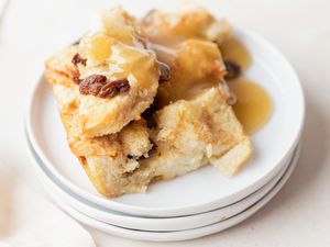 A stack of plates with easy bread pudding set on top.