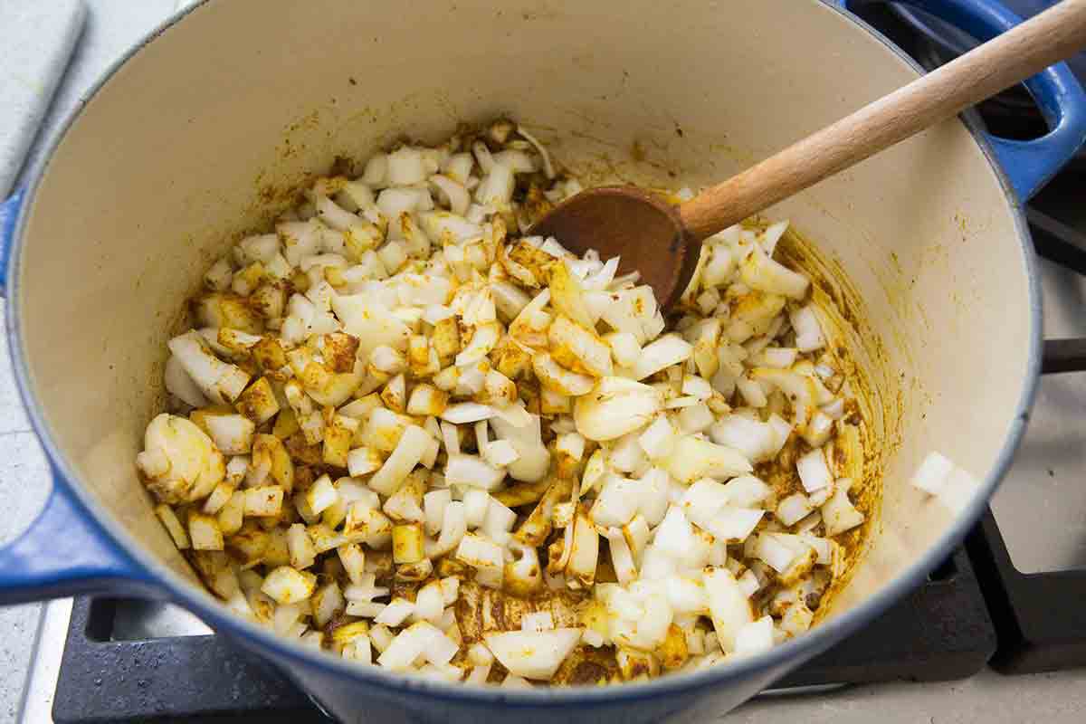 onions and garlic cooking in curry powder