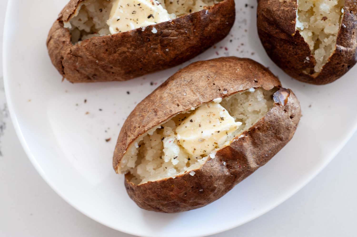 Air Fryer Baked Potatoes Topped with Butter