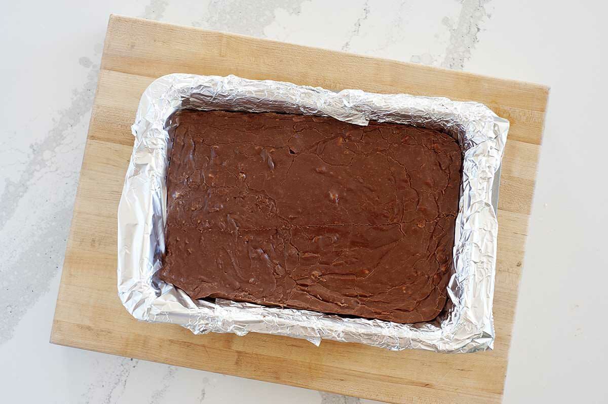 Fantasy fudge cooling in a pan with parchment.