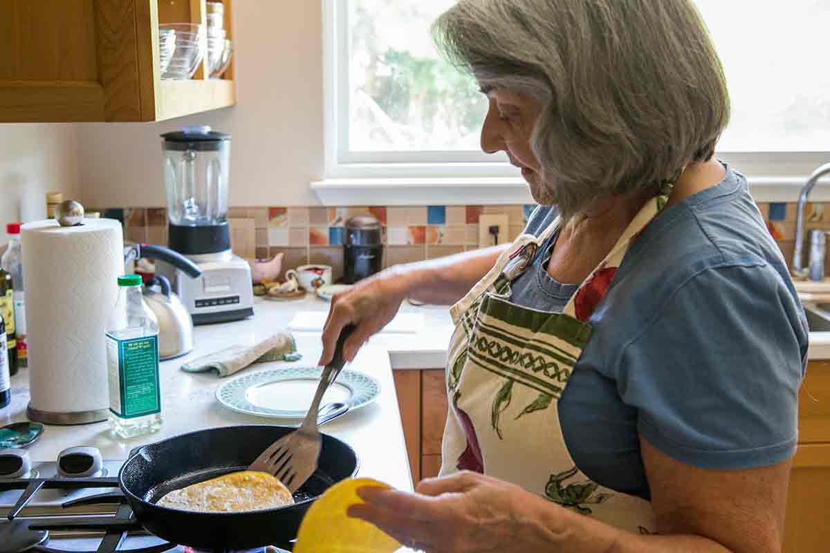 Elise's mother softening tortillas for enchiladas