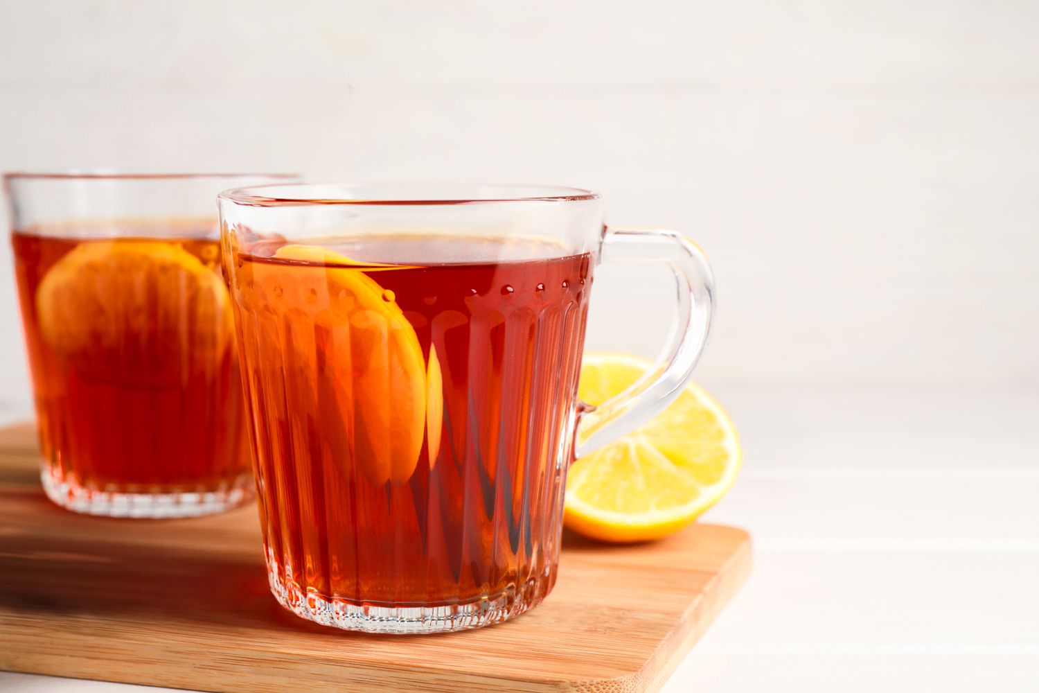 Glasses of ice tea on a wooden board 