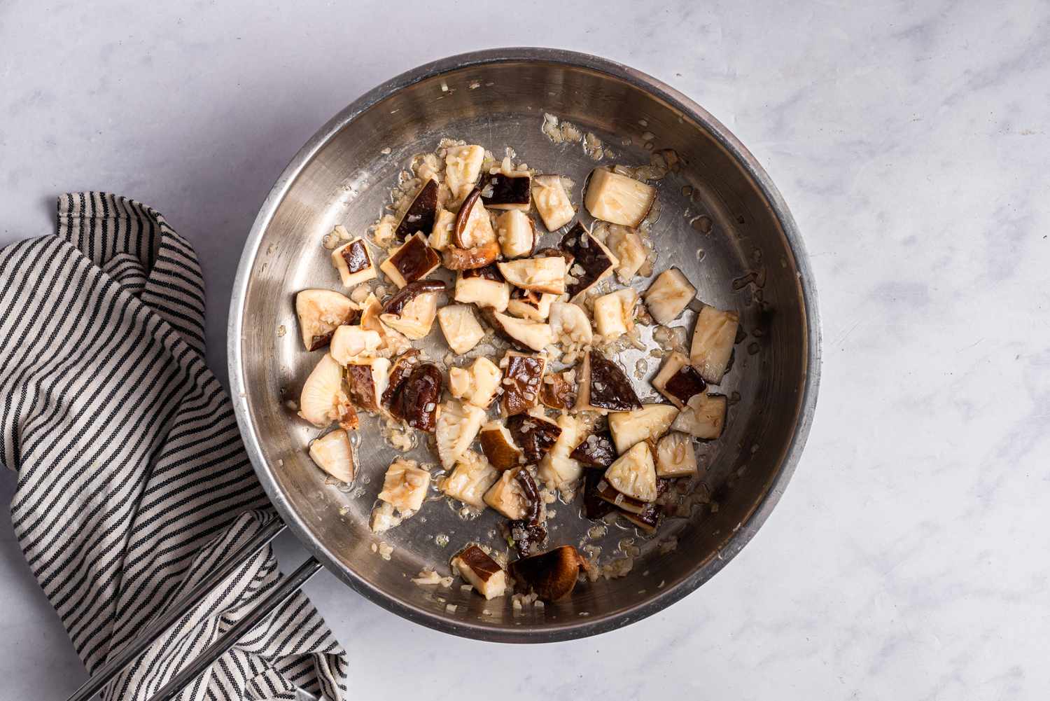 A pot of chopped mushrooms cooking 