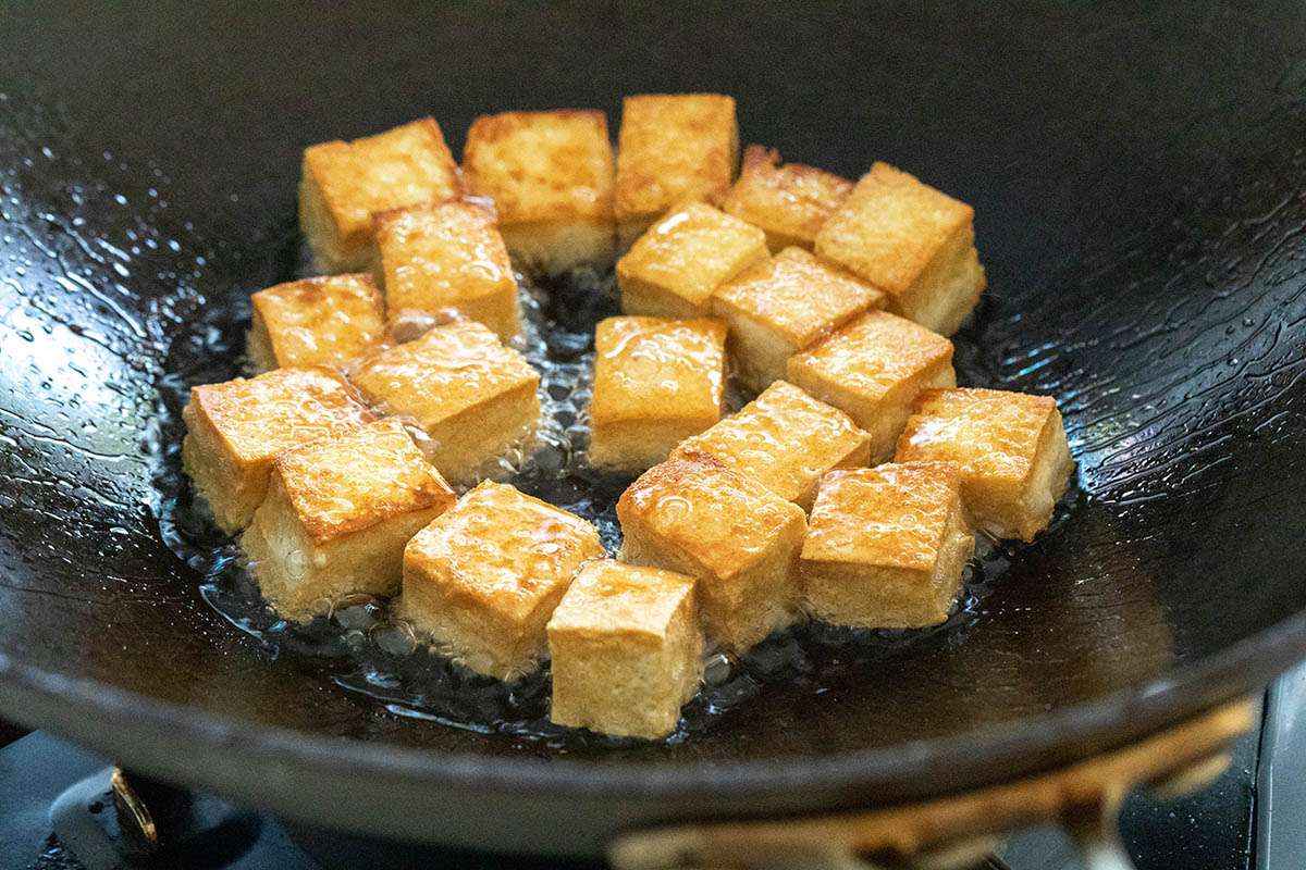 Cubed tofu in a wok to make Healthy Stir Fry.