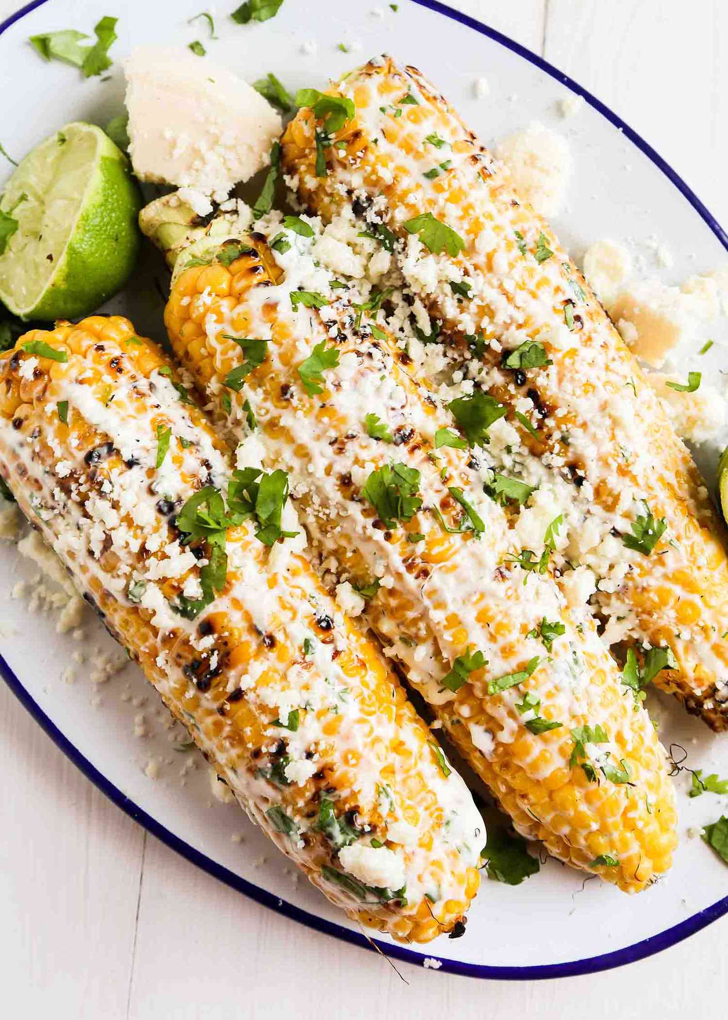 Mexican Corn or elote recipe with crema topping and cilantro