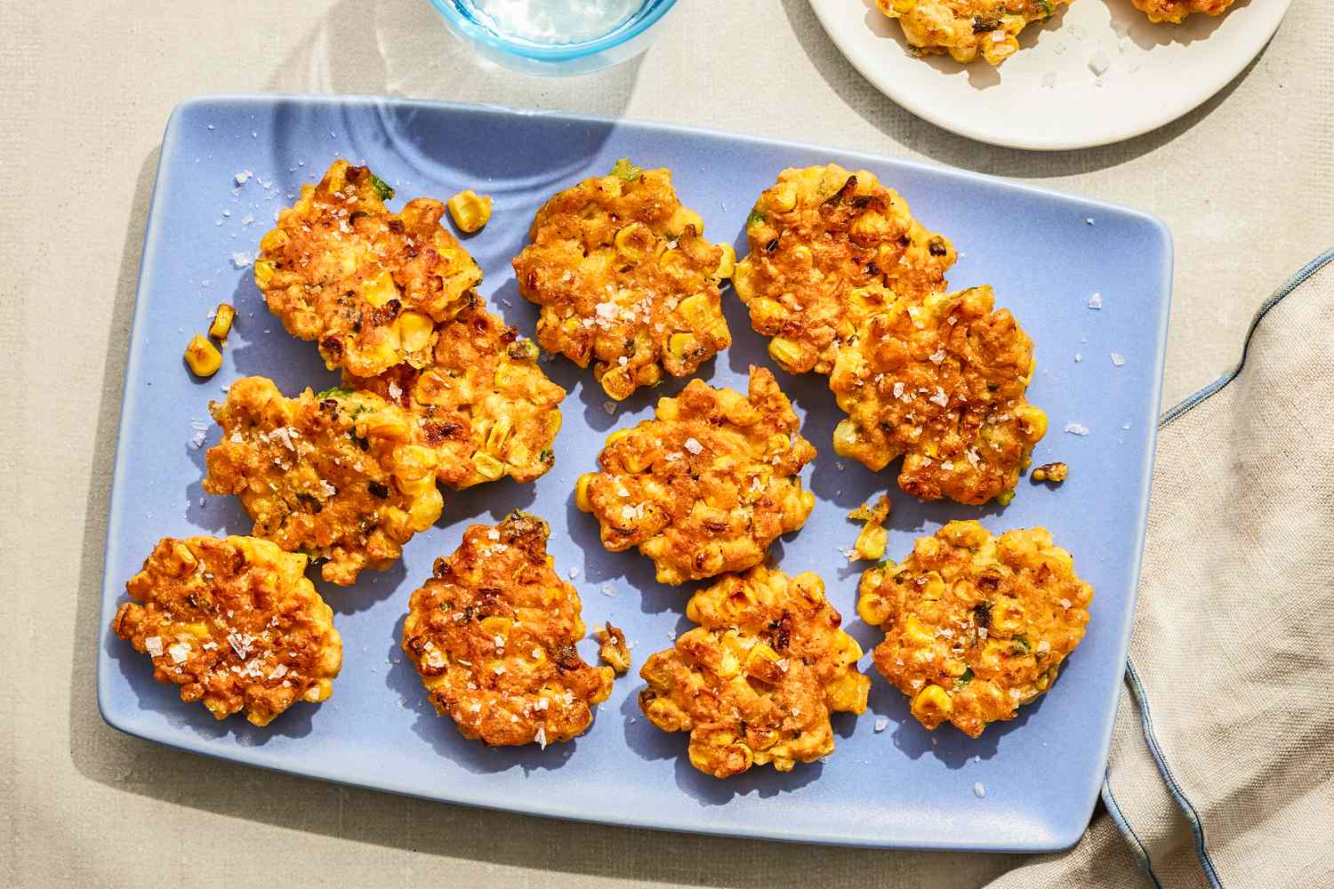Corn fritters arranged on a blue plate