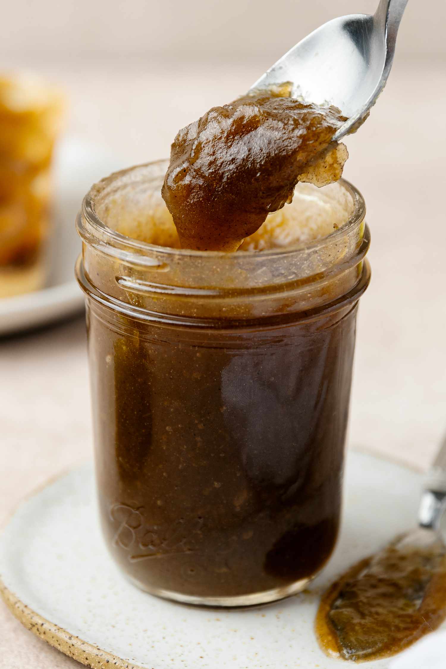 Jar of Old Fashioned Apple Butter with Some on a Spoon